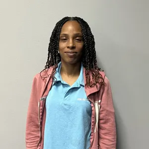 cleaner in blue shirt pink jacket